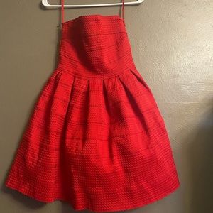 Woman’s red strapless dress